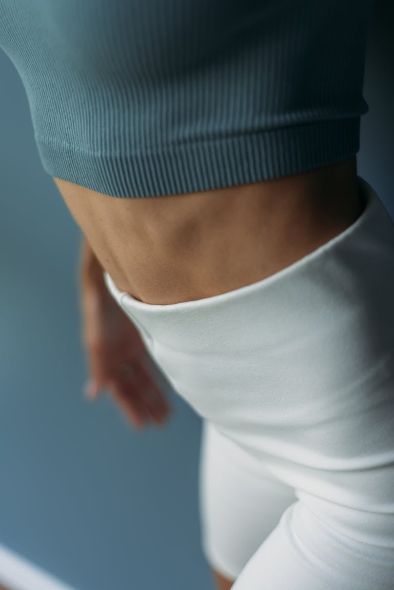 Close-up shot of a fit woman highlighting strong abs and a healthy lifestyle.